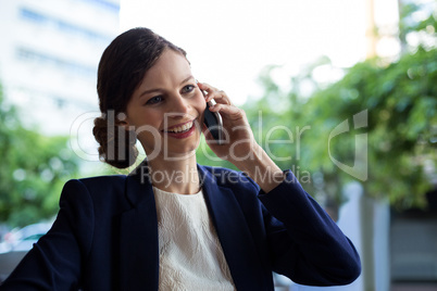 Businesswoman talking on mobile phone in cafe