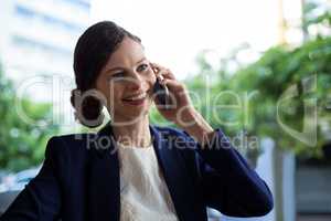 Businesswoman talking on mobile phone in cafe