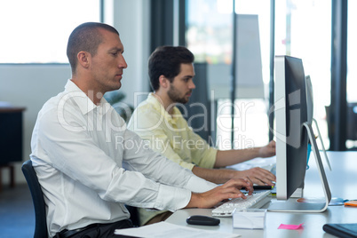 Attentive businessmen working on personal computer