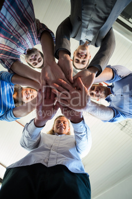 Team of businesspeople forming handstack