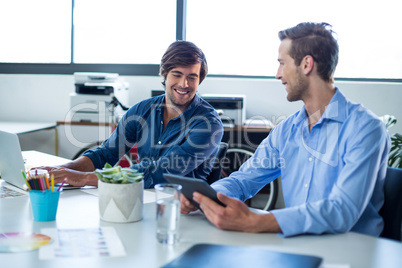 Two male graphic designers working together