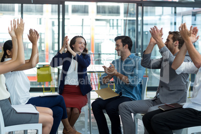 Business executives applauding after presentation