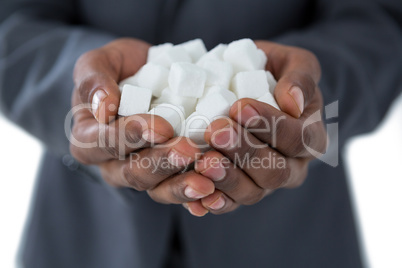 Mans hand cupped with sugar cubes
