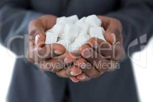 Mans hand cupped with sugar cubes