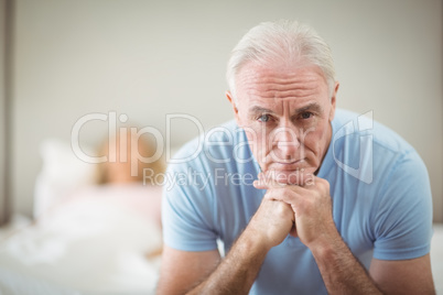 Worried senior man sitting at home