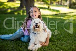 Portrait of girl with dog in park