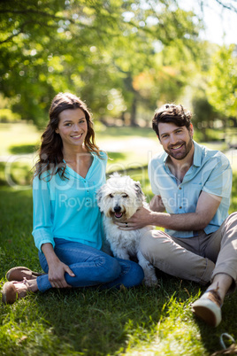 Portrait of couple with dog in park