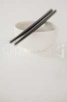 Pair of chopsticks over a bowl