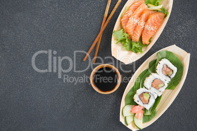 Sushi on boat shaped plate with chopsticks