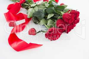 Bunch of red roses surrounded with heart shape chocolate