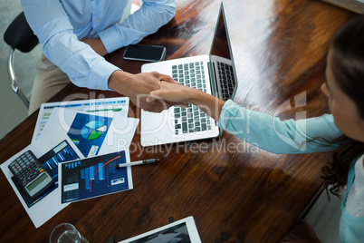 Business executives shaking hands during meeting