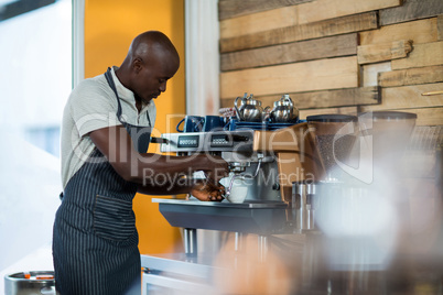 Waiter making a cup of coffee