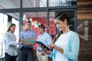 Attentive businesswoman using digital tablet
