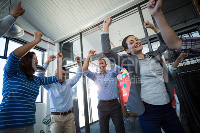 Team of businesspeople jumping in office