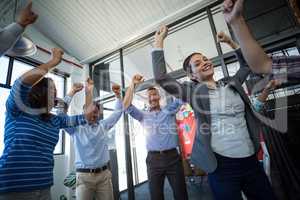 Team of businesspeople jumping in office