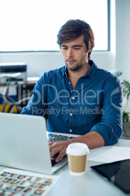 Attentive graphic designer working on laptop