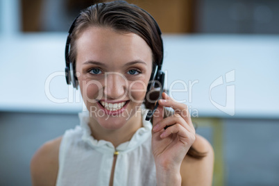 Business executive with headsets in office