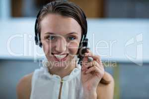 Business executive with headsets in office