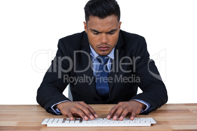 Businessman typing on keyboard at desk