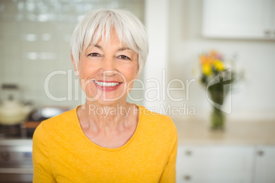 Happy senior woman in kitchen