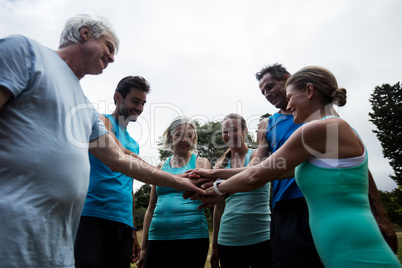 Athletes doing a hand stack in park