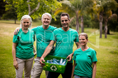 Recycling team members standing in park