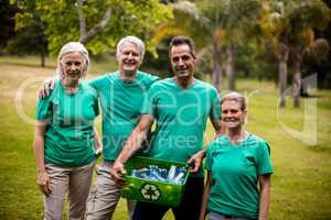 Recycling team members standing in park