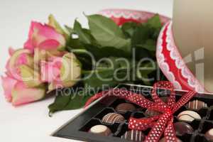 Bunch of roses and assorted chocolate box