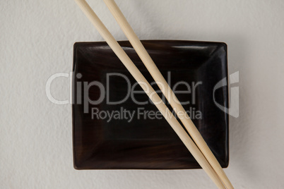 Pair of chopsticks over a bowl