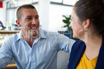 Smiling business executives interacting with each other