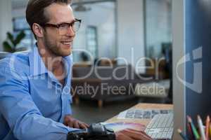 Male graphic designer working at desk