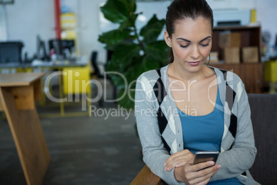 Female business executive using mobile phone