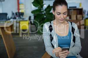 Female business executive using mobile phone