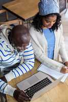 Smiling couple using laptop