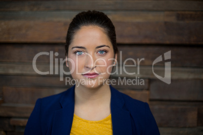 Confident female business executive standing in office