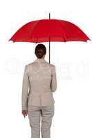Businesswoman holding red umbrella