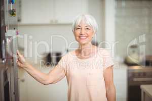 Portrait of senior woman standing in kitchen