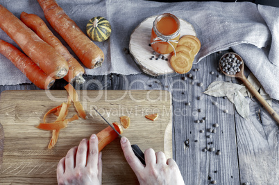process of slicing fresh carrots on a chopping board