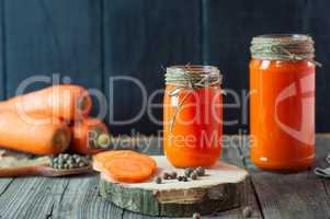Two glass jars with fresh carrot juice