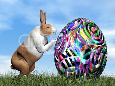 Rabbit pushing one colorful egg for Easter - 3D render