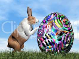 Rabbit pushing one colorful egg for Easter - 3D render