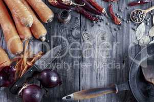 fresh vegetables and spices on gray wooden surface