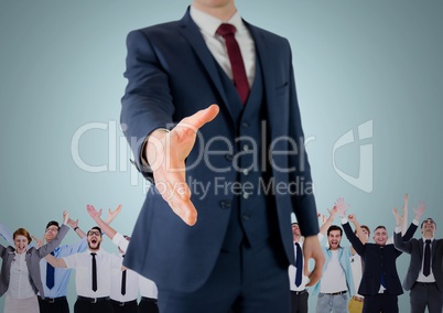 Composite image of Handshake in front of business people with blue background