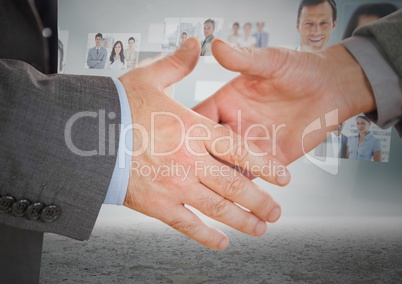 Composite image of Handshake in front of sky with business people