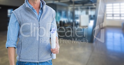 Man architect torso holding plans in an office