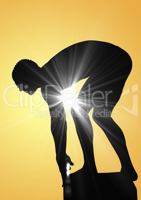 Swimmer silhouette with flare against a yellow background