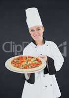 Chef with pizza against black background