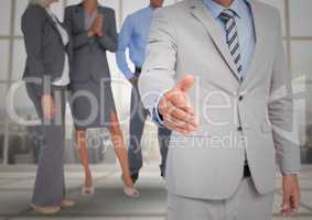 Handshake in front of business people at window