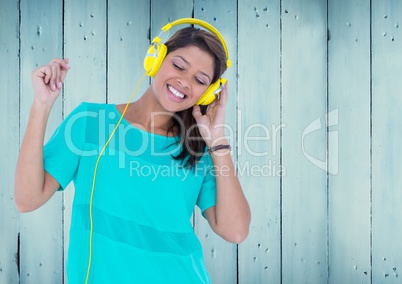 Composite image of Woman with headphones against blue wood panel