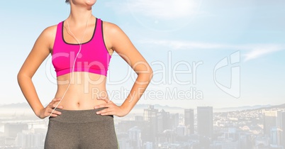 Fitness woman Torso listening music against sky background